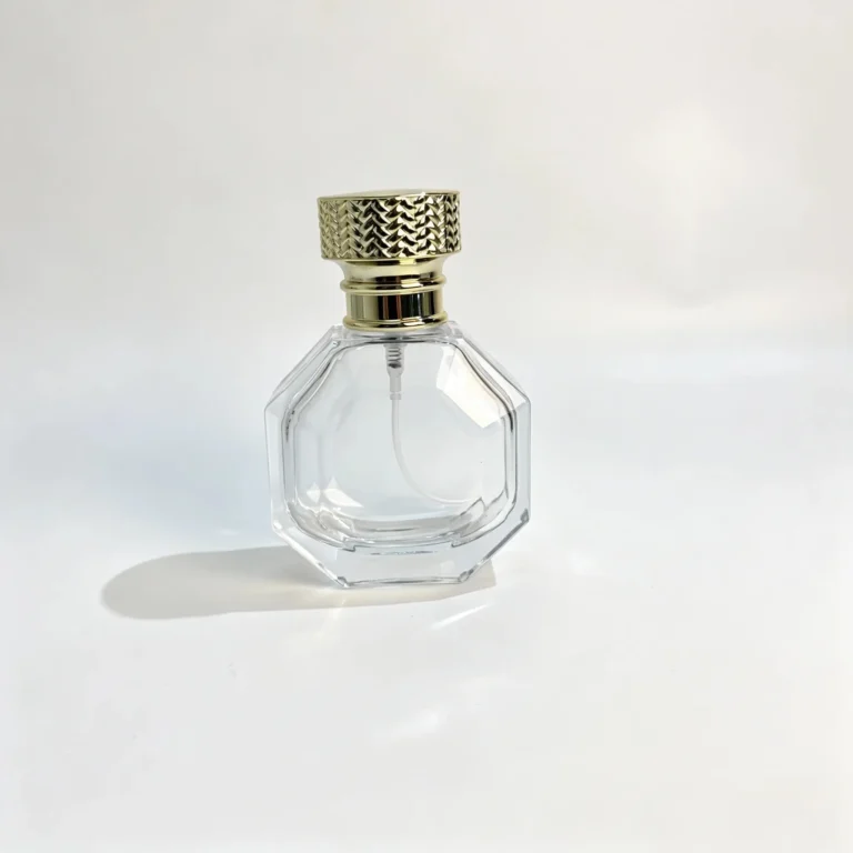 Front view of the 50ml octagonal perfume bottle with its decorative woven-style gold cap and assembled fragrance packaging design.