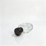 Side-lying view of the 50ml octagonal perfume bottle showing the geometric bottle profile and decorative black coil-design cap.