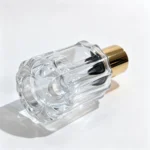 Side-lying 50ml petal fluted perfume bottle showing the bottle base and the vertical ribbing extending along its exterior.