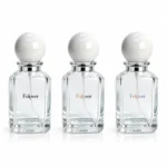 Custom logo printing reference for the 50ml square perfume bottle showing proposed branding designs on the bottle body with its white spherical cap.