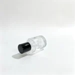Side-lying view of the 50ml stepped-neck perfume bottle highlighting the decorative cap and cylindrical bottle profile from a horizontal angle.
