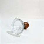 Side-lying view of the 50ml wide round perfume bottle showing the circular bottle base and the lower portion of its short body.