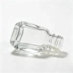 close-up showing the tapered glass body and flared base of the 5ml nail polish bottle