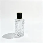 Rear view of the uncapped 80ml diamond-faceted perfume bottle showing the geometric bottle profile and its press-on neck opening.