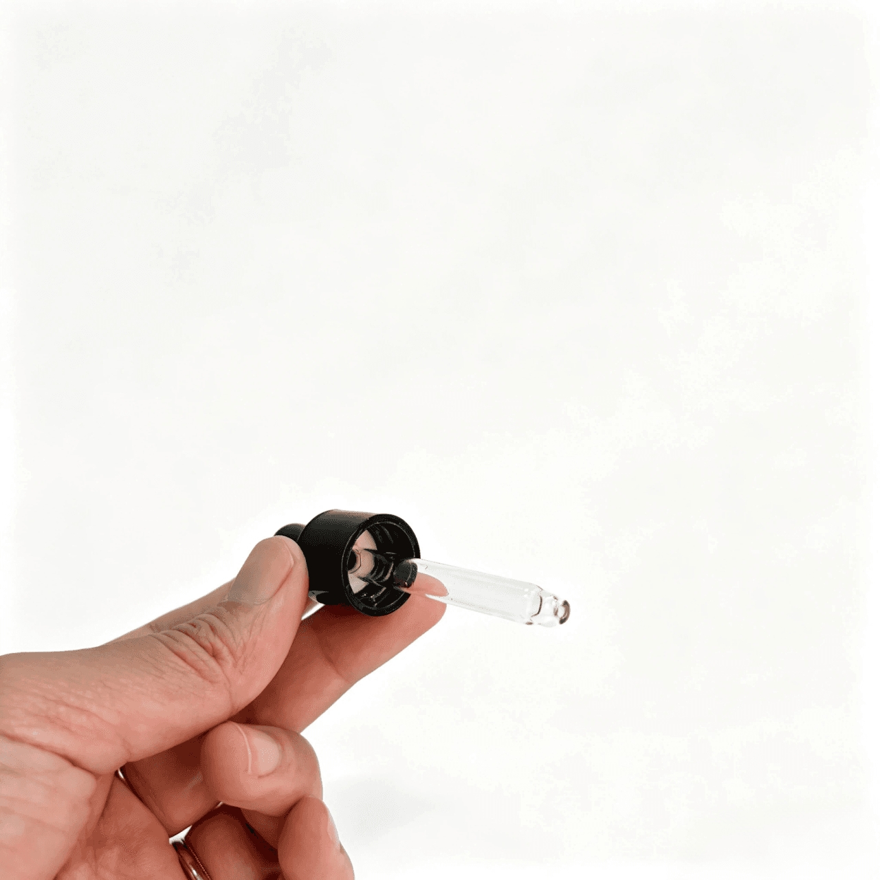 Side profile of mini pipette dropper showing glossy black aluminum collar, matte black rubber bulb, and transparent glass pipette