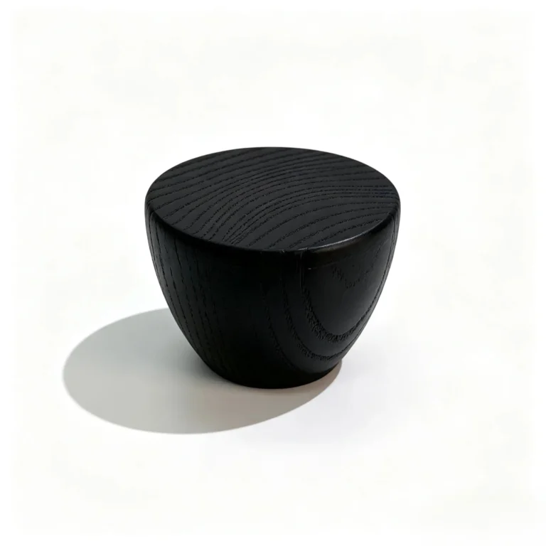Black round wooden perfume cap shown from the front with a smooth circular exterior profile for fragrance packaging