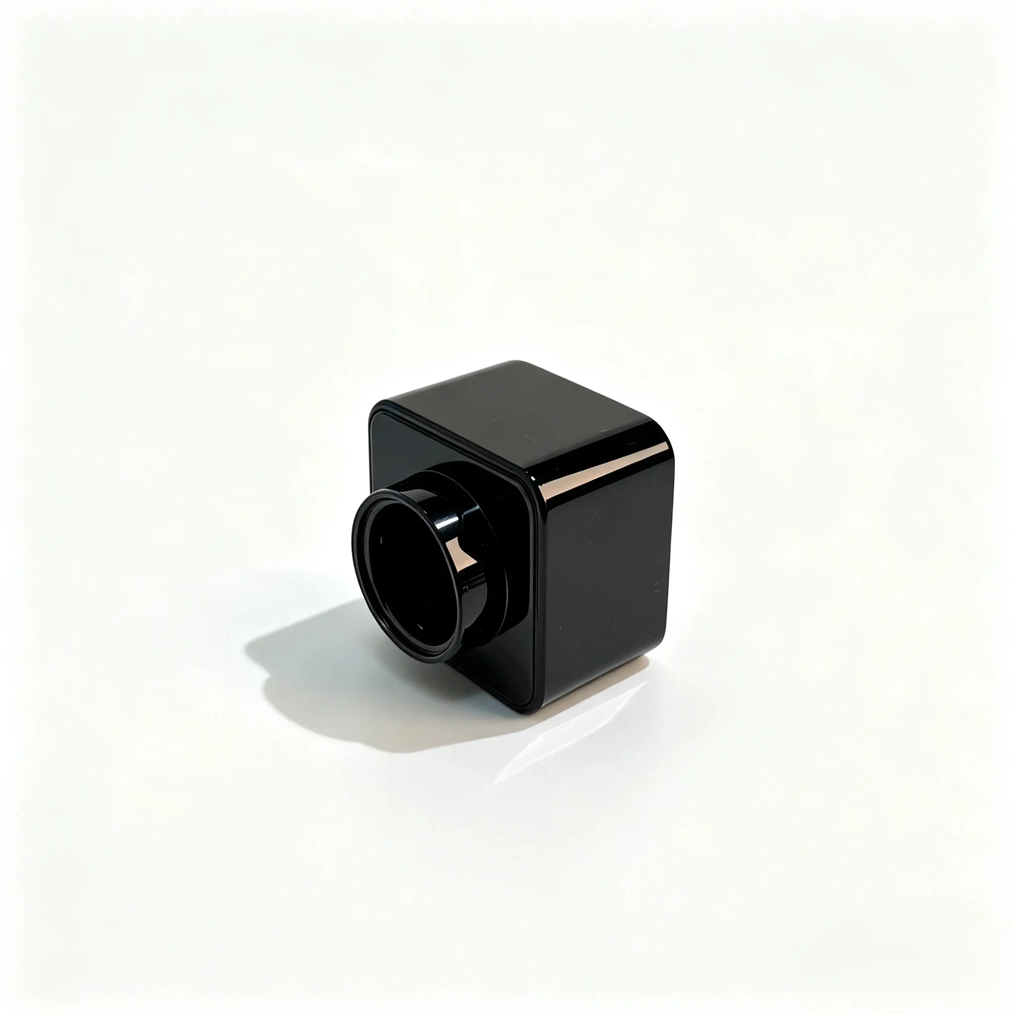 Vista izquierda de la abertura del tapón de perfume cuadrado negro ABS Tapón de perfume cuadrado negro ABS colocado horizontalmente con la abertura hacia la izquierda y el perfil lateral cuadrado visible