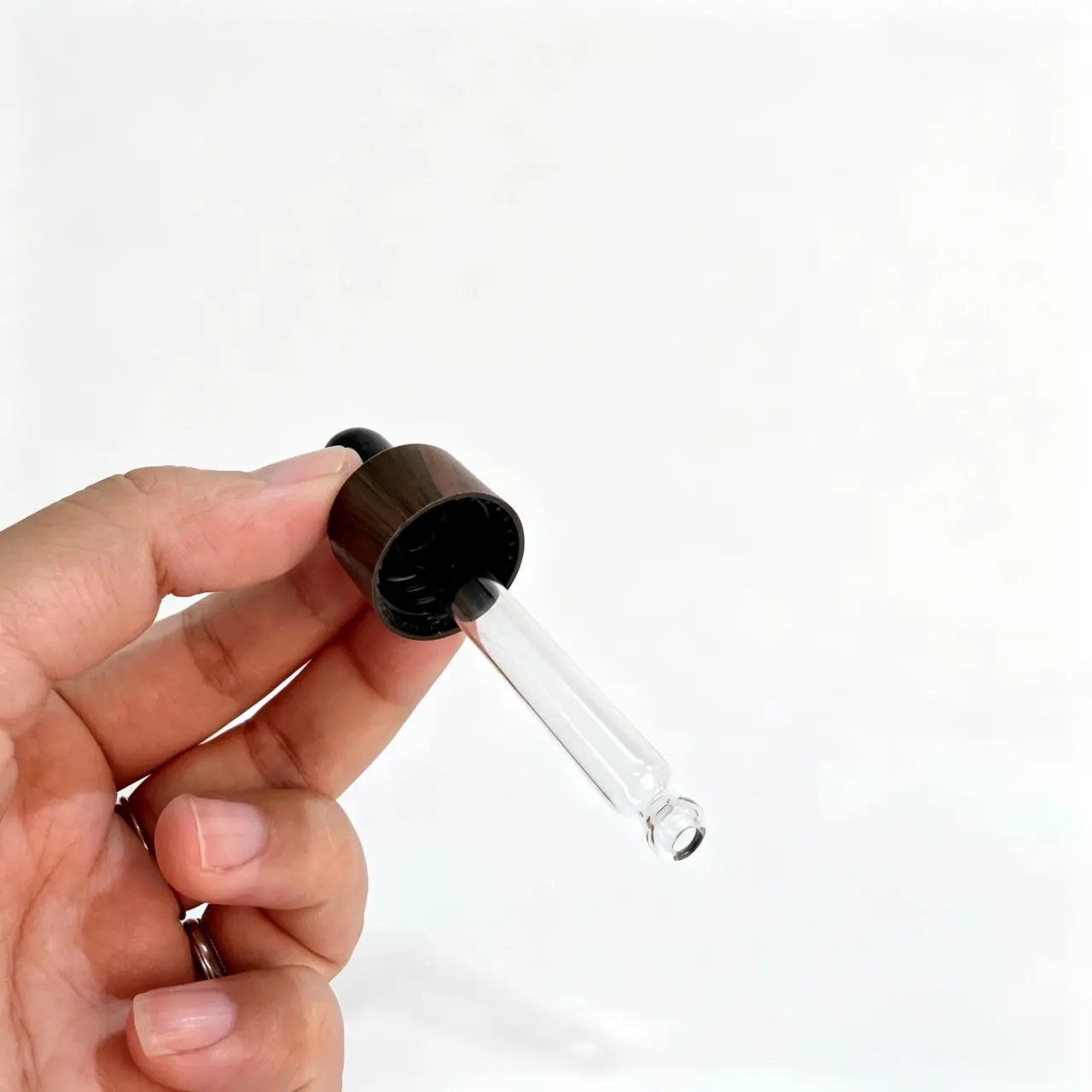 Wood Grain Aluminum Collar Glass Dropper Side View Side view of wood grain aluminum collar glass dropper showing black rubber bulb, decorative collar surface, and transparent glass pipette